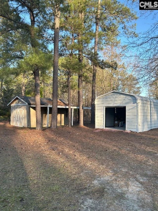 exterior space with an outbuilding, a storage unit, and a garage