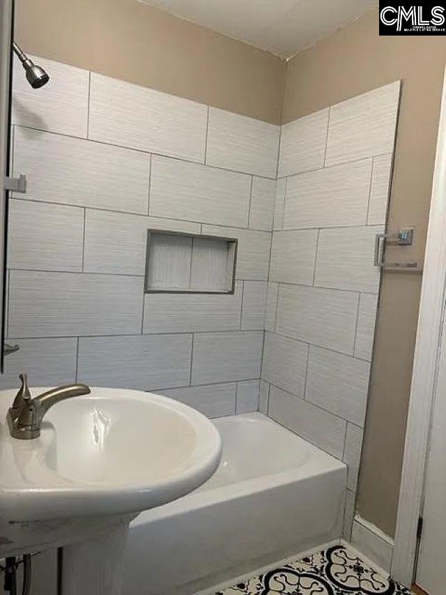 bathroom featuring tile patterned flooring and a sink