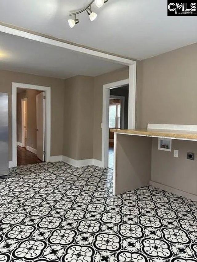 unfurnished room featuring baseboards