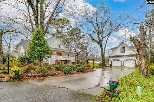 view of property exterior with a garage and covered porch