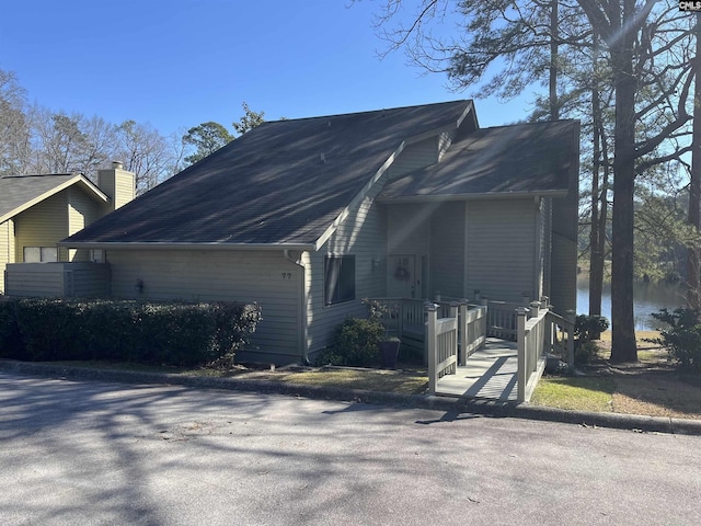 view of property exterior featuring a porch and a water view