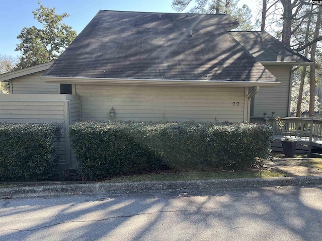 view of home's exterior featuring roof with shingles