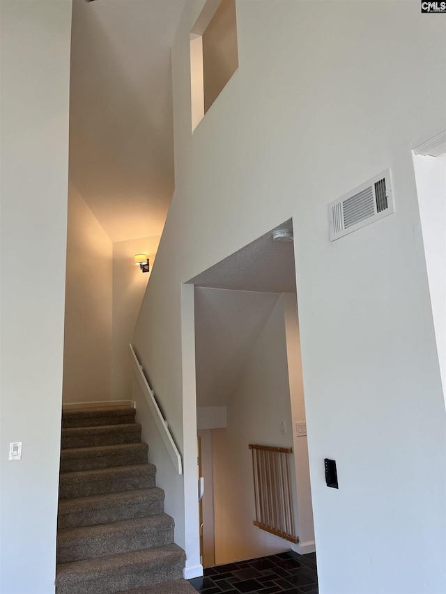 stairs featuring visible vents and baseboards