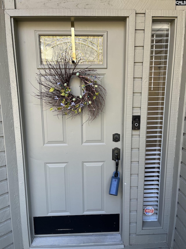 entrance to property featuring brick siding