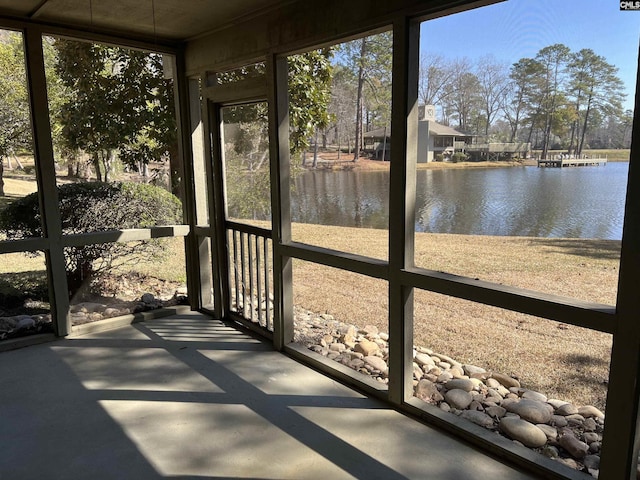 unfurnished sunroom with a water view