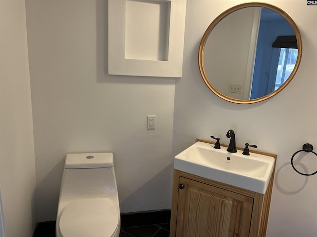 bathroom featuring toilet and vanity