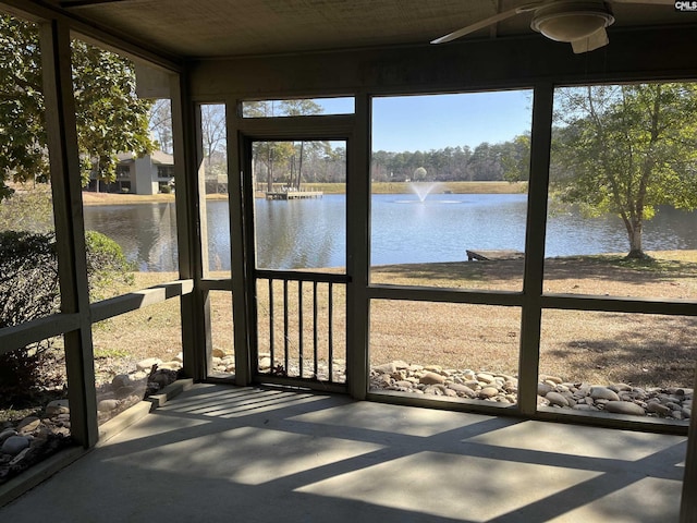 unfurnished sunroom with a water view