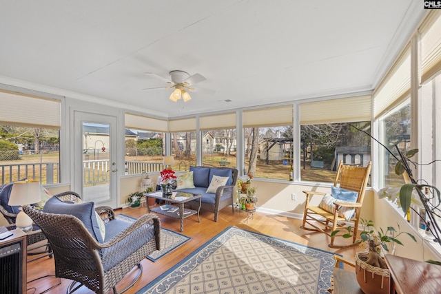 sunroom with plenty of natural light and ceiling fan