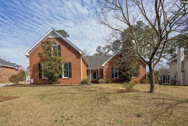 traditional home with brick siding and a front yard