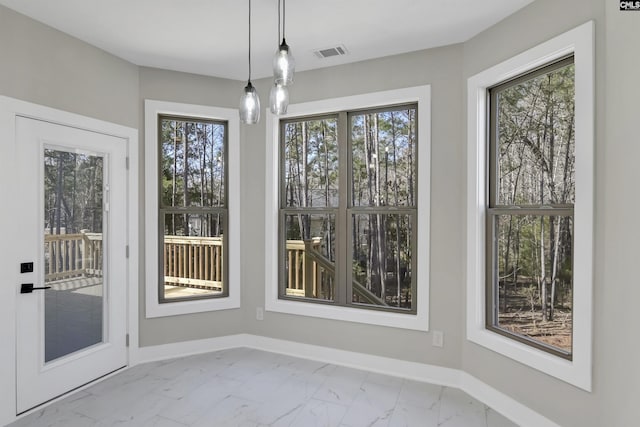 unfurnished dining area with visible vents, marble finish floor, and baseboards