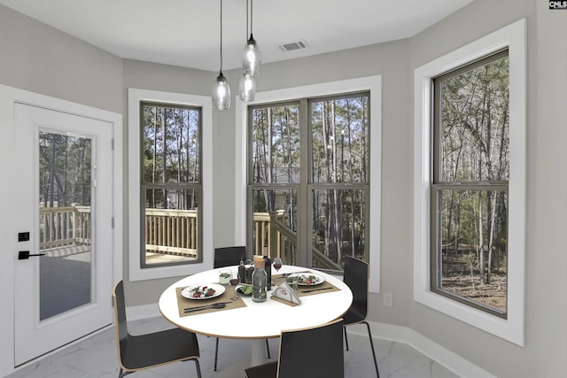 dining room with baseboards, visible vents, and marble finish floor