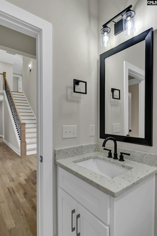 bathroom with vanity and wood finished floors