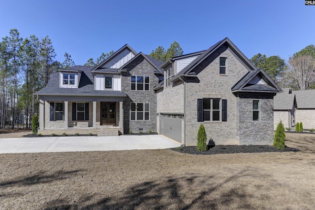 view of front of home featuring a porch, an attached garage, driveway, and brick siding