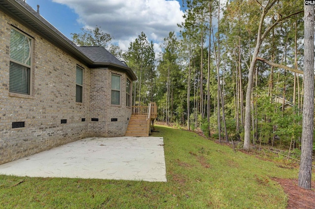 view of yard with a patio area, stairs, and a deck