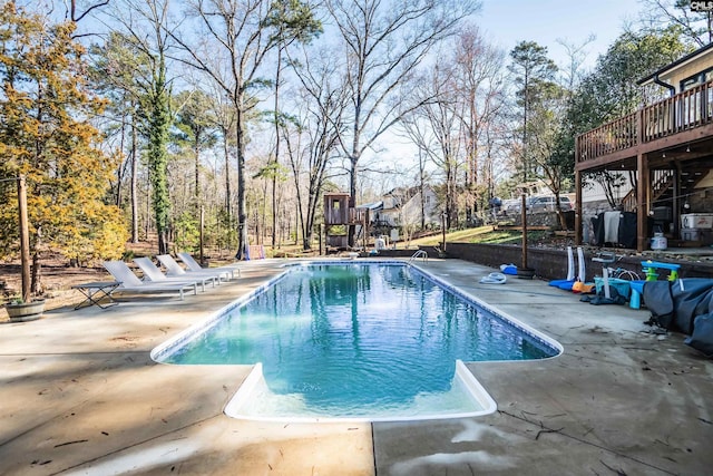 outdoor pool with a deck and a patio area