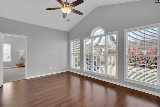 empty room with visible vents, high vaulted ceiling, baseboards, ceiling fan, and dark wood-style flooring