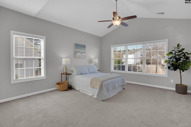 carpeted bedroom featuring visible vents, a ceiling fan, baseboards, and vaulted ceiling