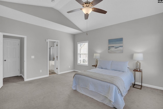 bedroom with a ceiling fan, carpet, baseboards, lofted ceiling, and ensuite bath