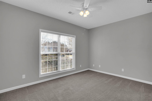 empty room featuring visible vents, baseboards, a ceiling fan, and carpet floors