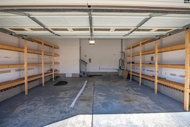 garage with water heater and a garage door opener