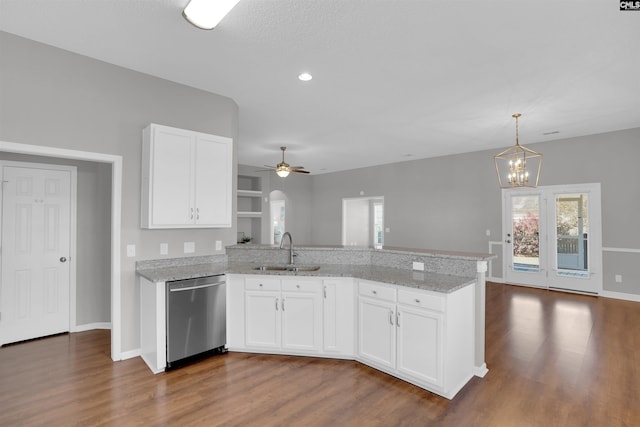 kitchen featuring dark wood finished floors, a sink, a peninsula, and stainless steel dishwasher