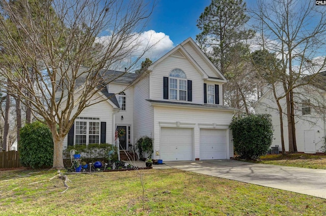 traditional-style home featuring concrete driveway, fence, a garage, and a front yard