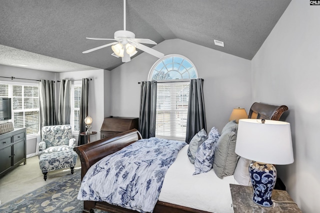 carpeted bedroom featuring a textured ceiling, a ceiling fan, and vaulted ceiling