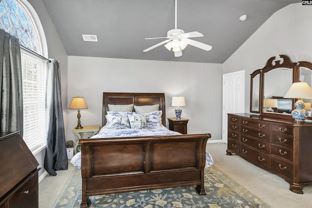 bedroom with visible vents, light colored carpet, a ceiling fan, and lofted ceiling