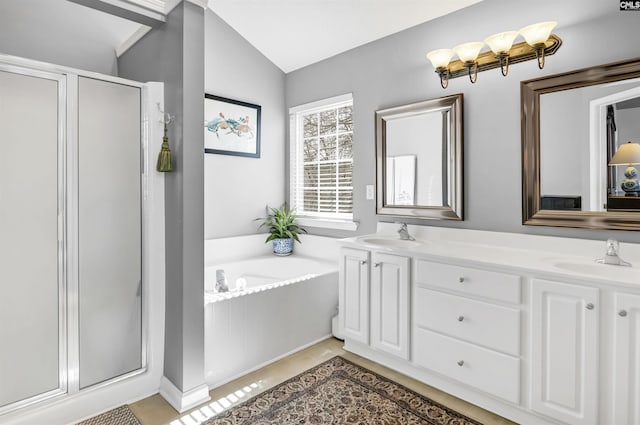 full bathroom featuring a sink, lofted ceiling, a bath, and a shower stall