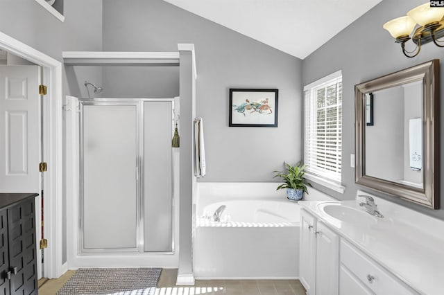 full bath with a bath, a stall shower, vanity, and lofted ceiling