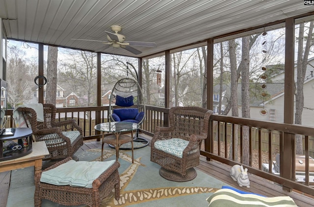 sunroom with a ceiling fan and a healthy amount of sunlight