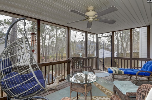 sunroom / solarium with a ceiling fan