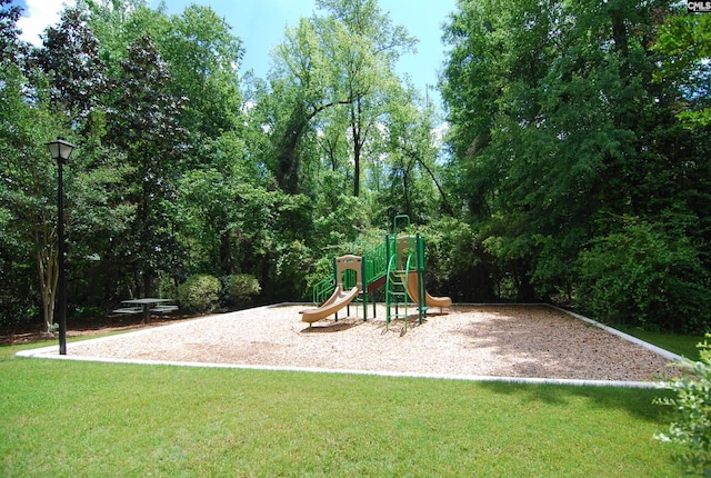 community playground featuring a lawn