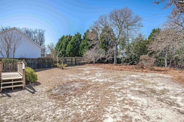 view of yard featuring a deck and fence