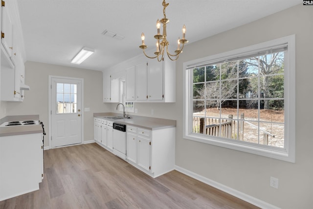 kitchen with visible vents, a sink, white cabinetry, white dishwasher, and light countertops