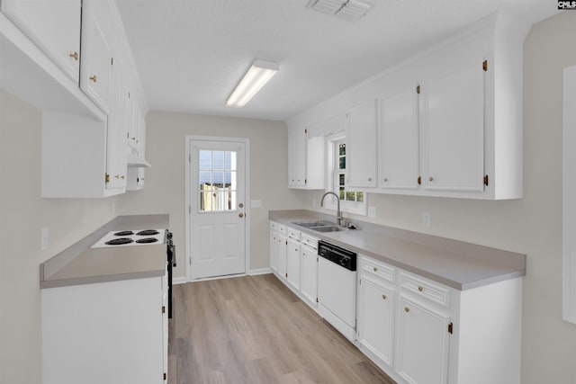 kitchen featuring visible vents, white cabinets, dishwasher, and a sink