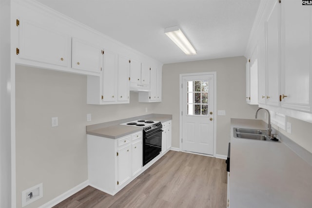 kitchen featuring electric range, a sink, white cabinetry, light wood finished floors, and light countertops