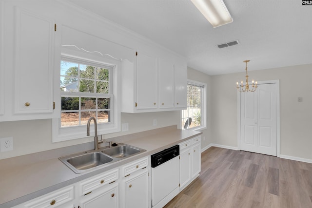 kitchen with visible vents, white dishwasher, a sink, light countertops, and white cabinets