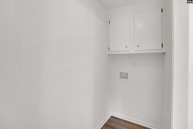 laundry area with washer hookup, wood finished floors, cabinet space, and baseboards