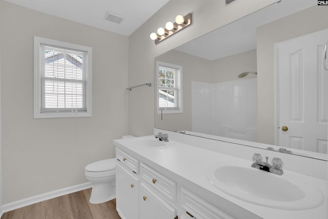 full bathroom featuring visible vents, toilet, a shower, and a sink