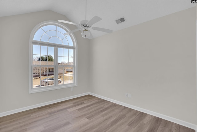 unfurnished room with visible vents, baseboards, and wood finished floors