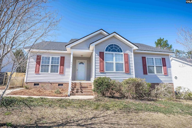 view of front of home with a shingled roof, fence, and crawl space