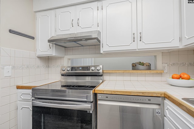 kitchen featuring under cabinet range hood, white cabinets, and stainless steel appliances