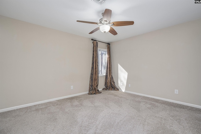 unfurnished room with carpet flooring, baseboards, and ceiling fan