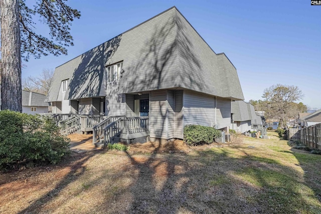 rear view of house with a shingled roof