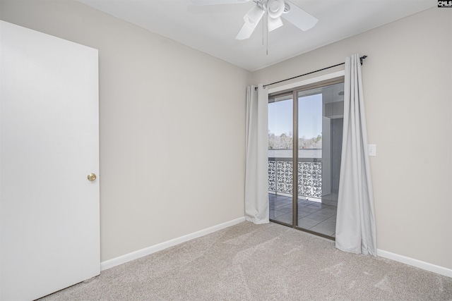 carpeted empty room with ceiling fan and baseboards