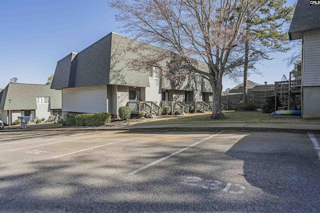 view of property featuring a residential view and uncovered parking