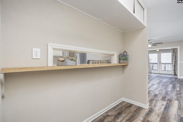 hall featuring baseboards and wood finished floors