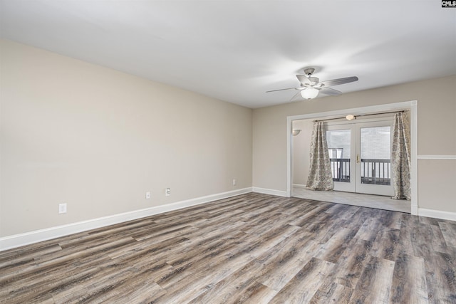 spare room with a ceiling fan, wood finished floors, french doors, and baseboards