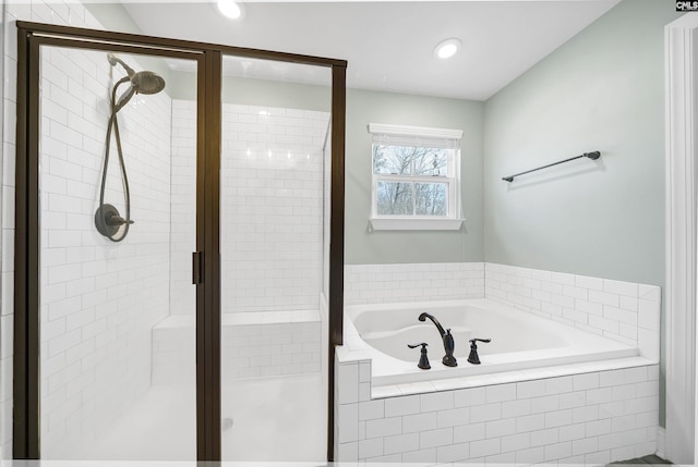 bathroom featuring recessed lighting, a stall shower, and a garden tub